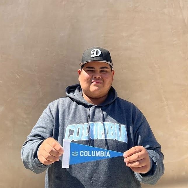 Boyle Heights native Justin Rios wearing a Columbia University sweatshirt and holding a Columbia pennant